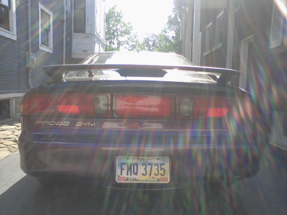 Dark purple 1995 Ford Probe rear view, showing spoiler and license plate FMQ 3735