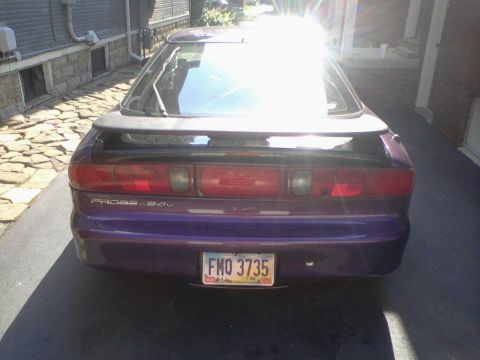1995 Ford Probe - The rear of a purple car is visible, a spoiler and a license plate.