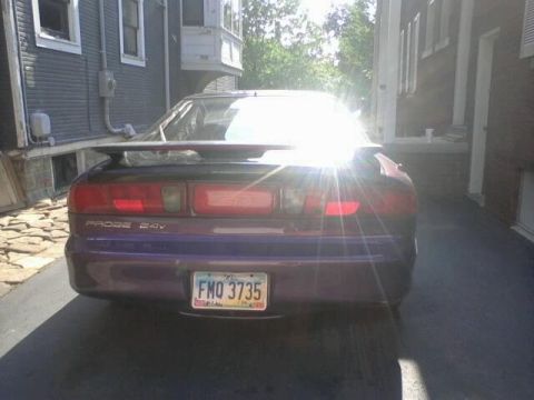 1995 Ford Probe - Rear view of a purple 1995 Ford Probe, showing its taillights, spoiler, and license plate.