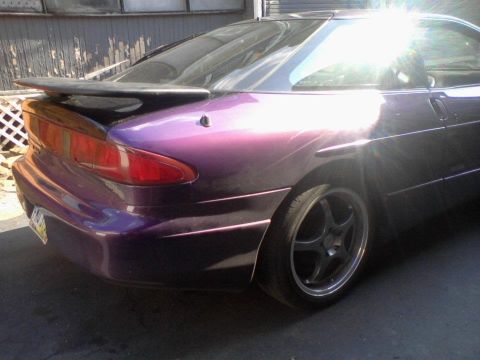 1995 Ford Probe - A purple 1995 Ford Probe is parked outdoors, showing its rear end and a spoiler.