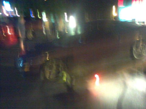 1995 Ford Probe - Nighttime photo shows a blurred vehicle, possibly a car, with indistinct lights in the background.