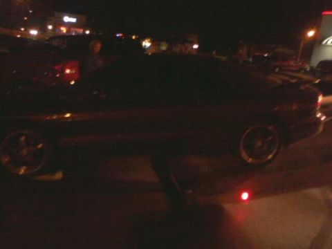 1995 Ford Probe - A dark coupe is seen from the side at night, with a Supermotors logo visible in the lower right corner.