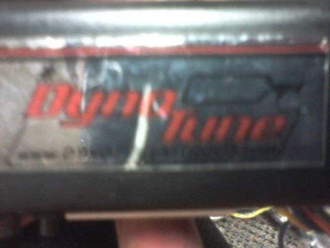 1995 Ford Probe - A close-up shows a "DynoTune" sticker, indicating a part or modification, not a specific vehicle year.