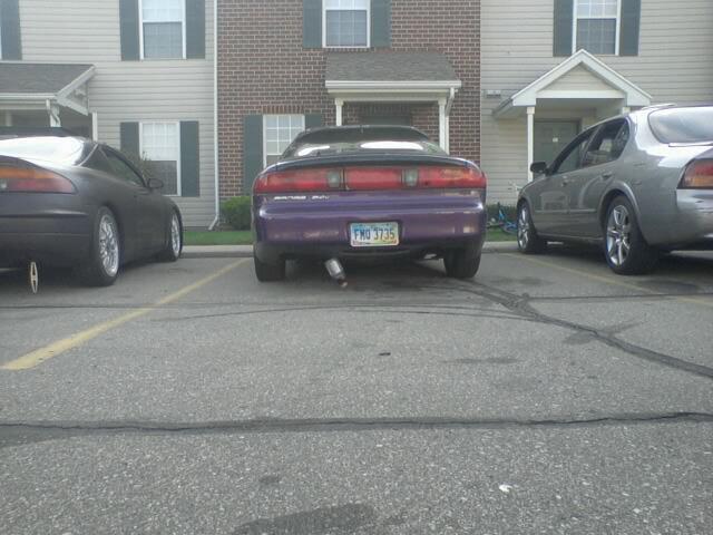 Rear view of a purple 1995 Ford Probe with license plate FMD 3735.