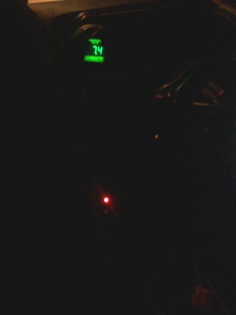 1995 Ford Probe - A dimly lit interior shot shows a digital gauge displaying "74" in green, with a small red indicator light visible below it.