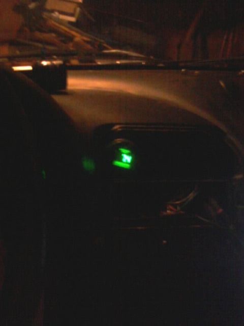 1995 Ford Probe - A close-up view of a car's dashboard at night, showing a green digital display with the number "34" illuminated.