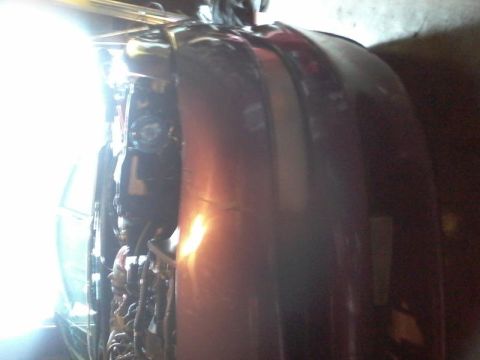 1995 Ford Probe - A close-up, angled view of the front passenger side of a custom car, showing the fender and part of the bumper. The vehicle has a metallic…