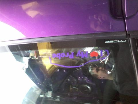 1995 Ford Probe - A purple vehicle's rear window features a purple decal that reads "My Probe" with a red heart. The word "PROBE" is also visible in white te…