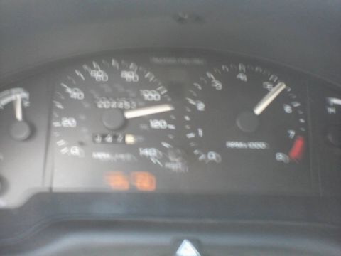1995 Ford Probe - The image shows a close-up of a car's dashboard, focusing on the speedometer and tachometer. The speedometer needle is near 120 mph, and th…