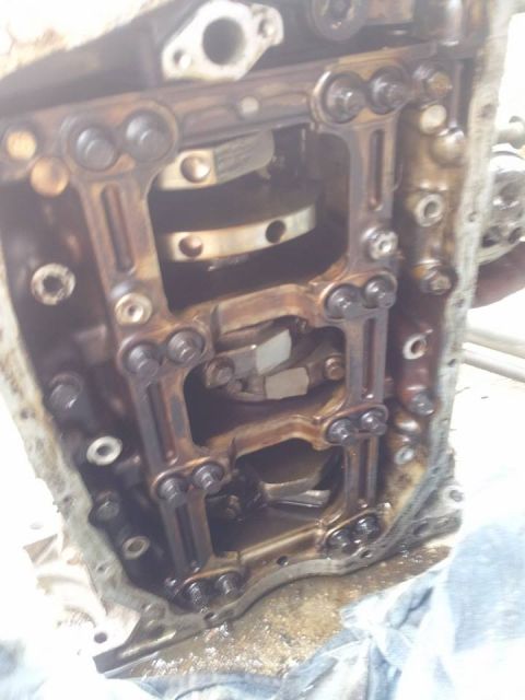 1995 Ford Probe - This is a close-up view of the internal components of a vehicle engine, likely the crankshaft and connecting rods within the engine block.…