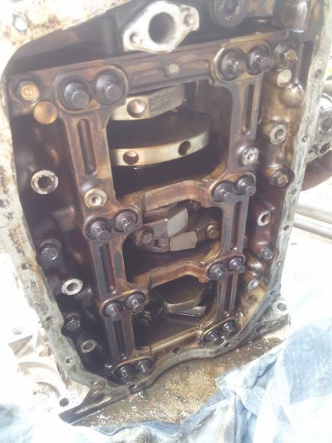 1995 Ford Probe - This is a close-up, angled view of the internal components of a vehicle engine, likely the crankshaft and connecting rods, showing heavy oi…
