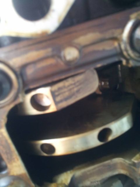 1995 Ford Probe - This is a close-up, blurry shot of internal engine components, likely a crankshaft and connecting rod mechanism. The metal parts show signs…