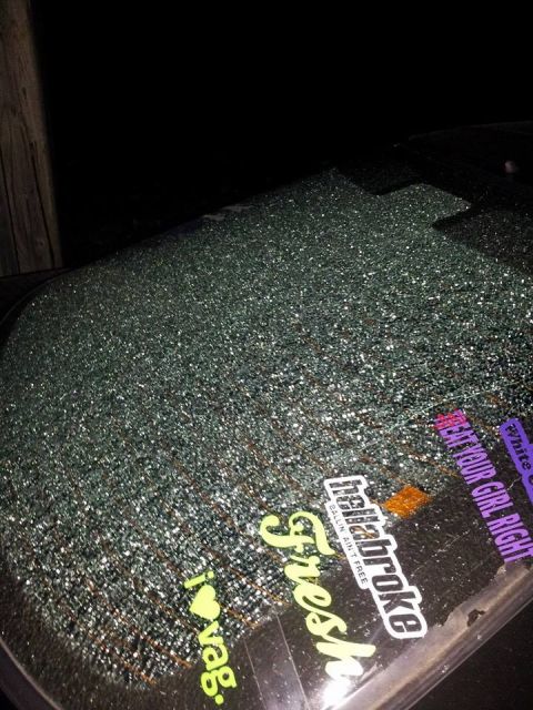 1995 Ford Probe - The shattered rear window of a 1995 Ford Probe is covered in glittery stickers. Visible stickers include "fresh", "ballin ain't free", and…