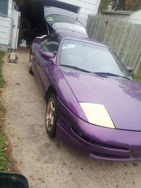 1995 Ford Probe - A purple 1995 Ford Probe is parked in a driveway with its trunk open. A sticker on the windshield reads "I Hate When People Sell a Boat".