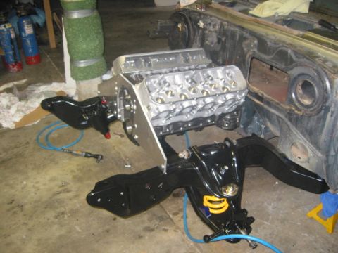 1973 Ford Ranchero - Engine and front suspension parts are laid out on the floor, ready for installation.
