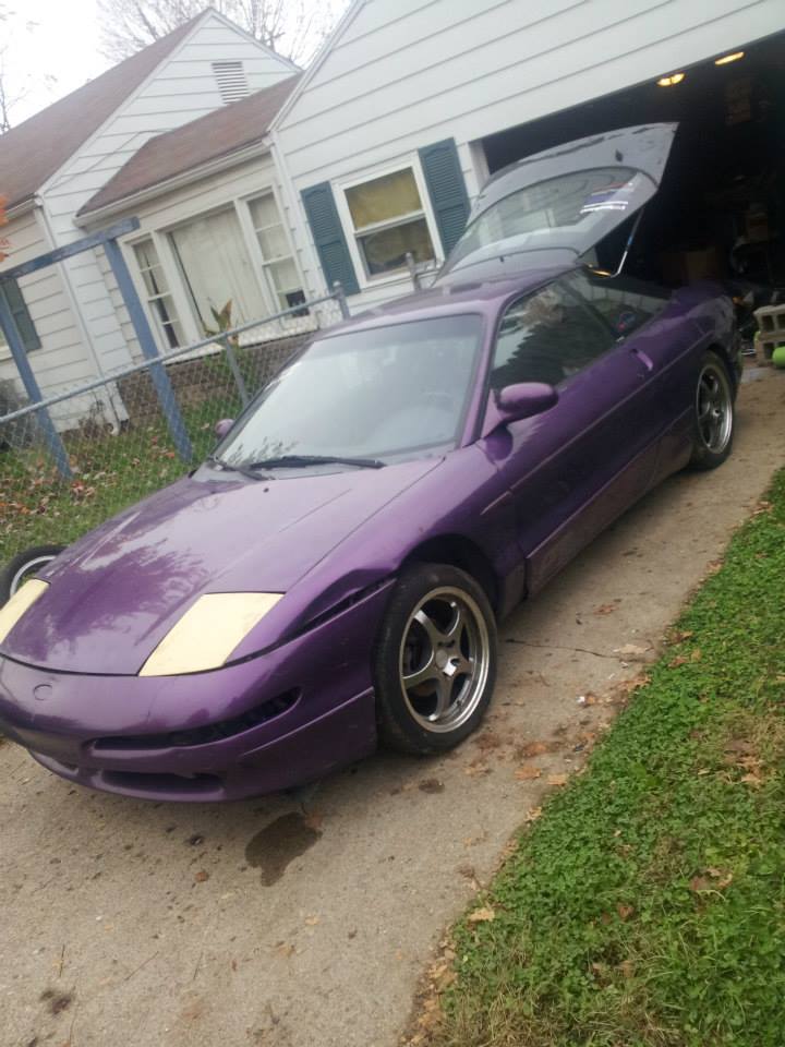 Purple 1995 Ford Probe with trunk open, parked in driveway.