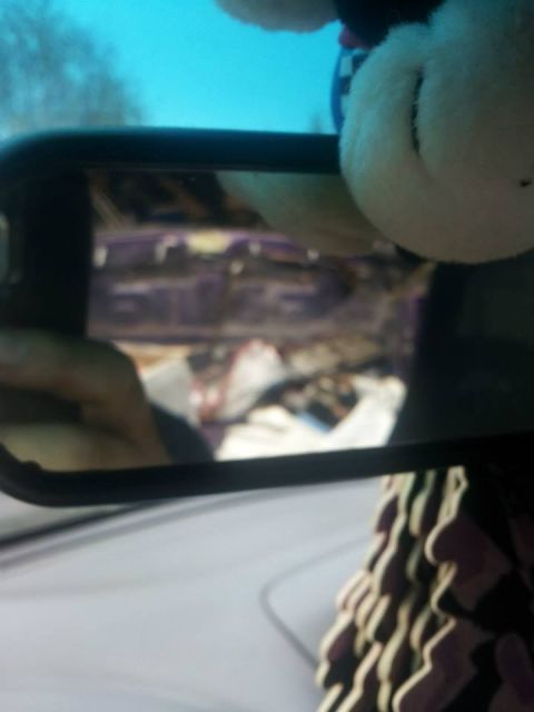 1995 Ford Probe - A close-up reflection in a car's side mirror shows the interior of the vehicle, including a hand and what appears to be items in the back s…