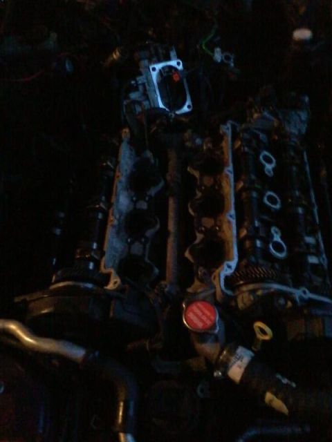 1995 Ford Probe - The image shows a close-up view of a car engine, likely a V6, with various components visible. A red radiator cap is prominent, along with…