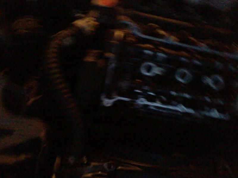 Blurry close-up of vehicle engine component with circular openings.