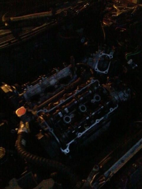 1995 Ford Probe - The image shows a close-up view of an engine, likely from a 1995 Ford Probe, with the valve cover removed, revealing the camshafts and othe…