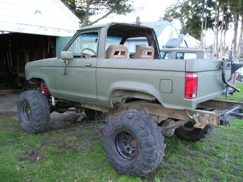 1986 Ford Bronco II - This modified 1986 Ford Bronco II features a lifted suspension and oversized off-road tires, suggesting it's built for terrain.