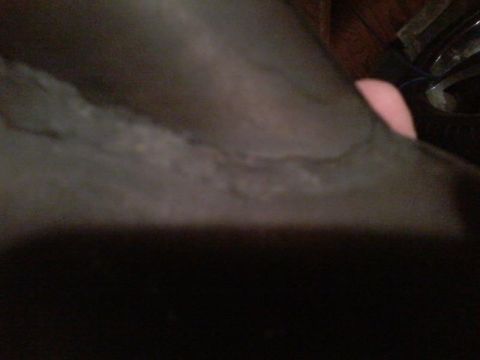 1995 Ford Probe - A close-up, blurry view of a dark gray car interior with a pinkish object, possibly a hand, visible in the upper right quadrant.