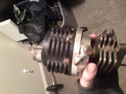1995 Ford Probe - A hand holds a modified turbocharger with prominent fins and a silver band. The turbocharger appears to be attached to a metal rod, possibl…