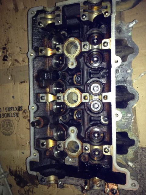 1995 Ford Probe - This is a close-up, overhead view of the internal components of a vehicle's engine cylinder head. The metallic parts are covered in dark oi…