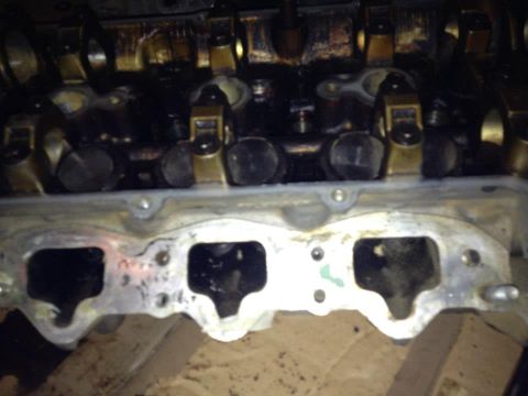 1995 Ford Probe - This is a close-up, overhead view of the intake manifold and valve train of a vehicle engine. The metal components are dirty and appear to…