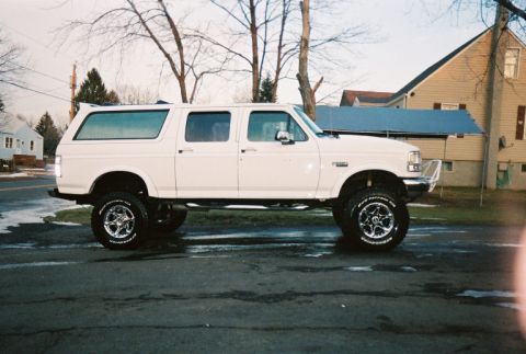 1996 Ford C-250 (Centurion Conversions) - This lifted 1996 Ford C-250 Centurion Conversion features a side profile view with prominent chrome wheels.
