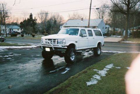 1996 Ford C-250 (Centurion Conversions) - White 1996 Ford C-250 (Centurion Conversions) SUV with a lift kit and custom bumper.