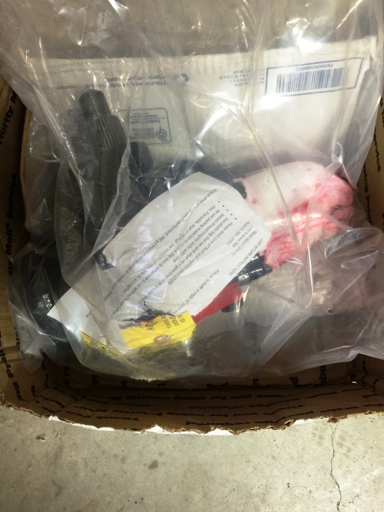 Automotive part in plastic wrap inside a box