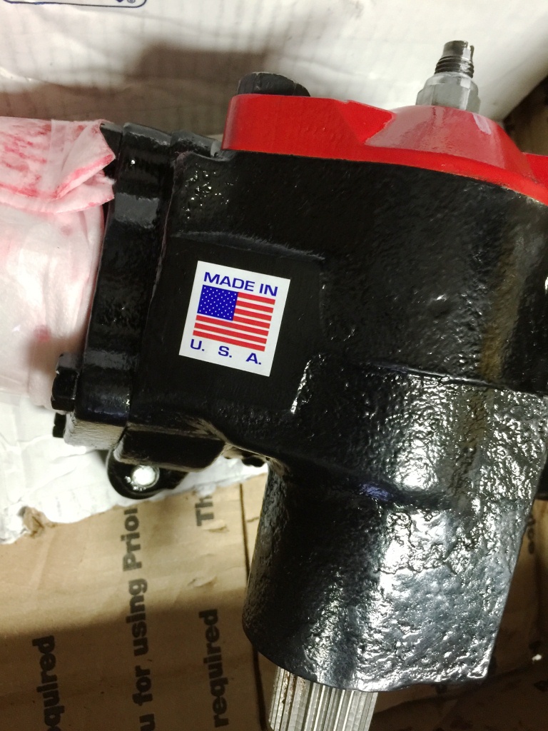 Black steering gear box with red accent and USA sticker, partially wrapped.