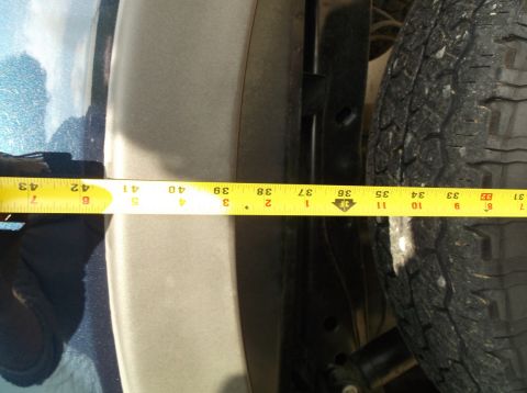 2005 Ford F-150 - A measuring tape is used to show the clearance between a tire and the fender well.