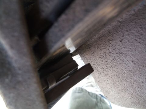 2005 Ford F-150 - Detail view of a vehicle's brake caliper and rotor, likely taken during maintenance or inspection.
