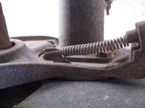 2005 Ford F-150 - A close-up view of a vehicle's brake drum assembly, showing rust and a tension spring.