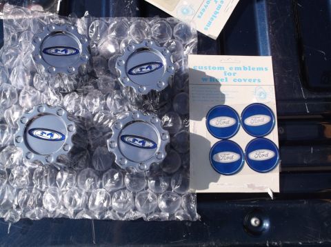 2005 Ford F-150 - Set of four wheel center caps and custom Ford emblems for wheel covers, likely for a truck.