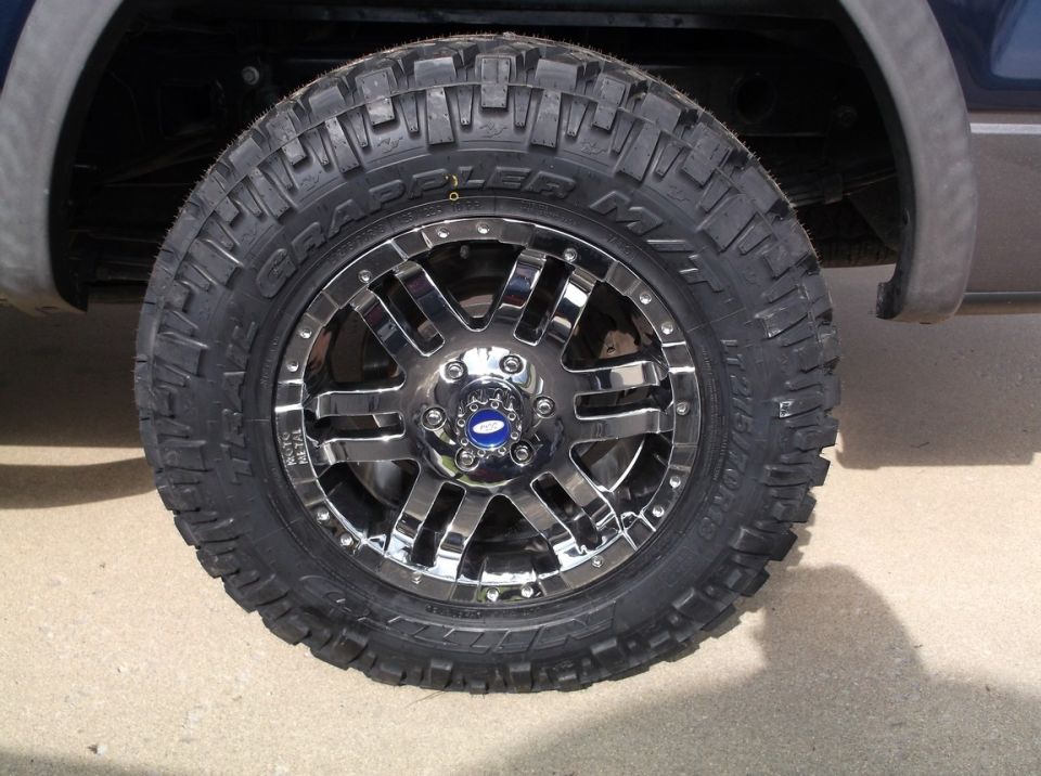 Chrome 5-spoke wheel with BFGoodrich All-Terrain T/A KO2 tires on a truck
