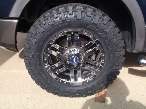 2005 Ford F-150 - A close-up of a chrome wheel and tire on a truck, with visible tire size information.