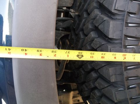 2005 Ford F-150 - Measurement of tire clearance within the fender well, showing the tire and part of the vehicle's body.