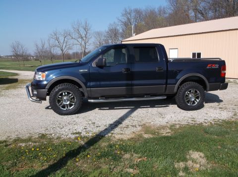 2005 Ford F-150 - This 2005 Ford F-150 FX4 pickup truck is shown from the side, aftermarket wheels and tires.