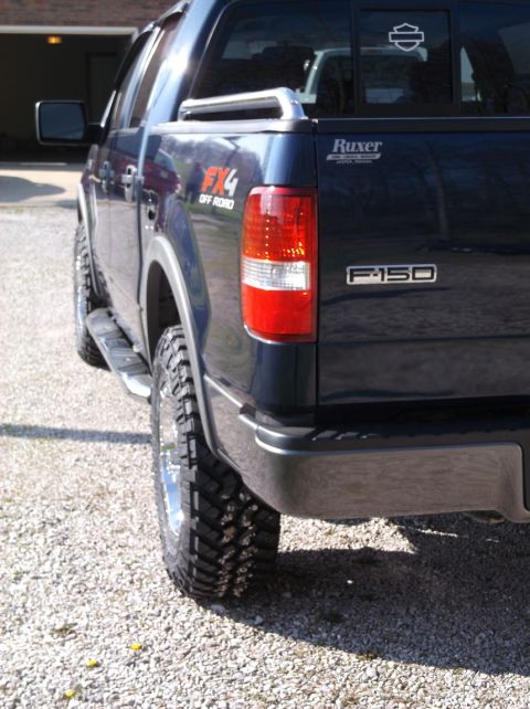 2005 Ford F-150 - Rear view of a dark blue Ford F-150 FX4 pickup truck with aftermarket wheels and tires.
