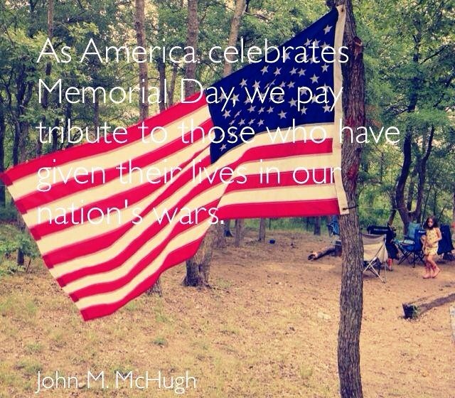 American flag in a wooded area with text about Memorial Day and a campsite in the background