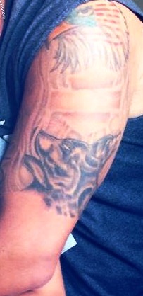 1996 Ford Bronco - A tattoo a skull and palm trees is visible on an arm, with a Supermotors logo at the bottom.
