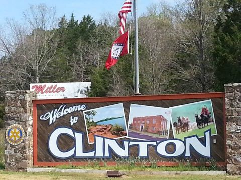 1996 Ford Bronco - A sign welcomes visitors to Clinton, local landmarks and flags.