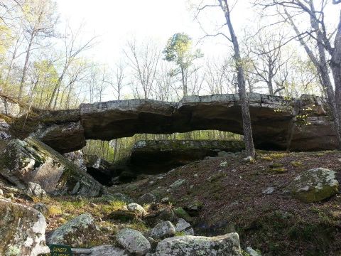 1996 Ford Bronco - Natural rock bridge formation in a wooded area, with a warning sign for no climbing.