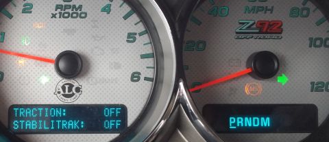 1978 Chevrolet C/K Pickup - Close-up of vehicle dashboard gauges, showing the Z71 Off Road badge and the status of traction control and stabilitrak systems.