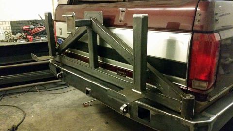 1996 Ford Bronco - A heavy-duty custom rear bumper with a swing-away spare tire mount is attached to a pickup truck.