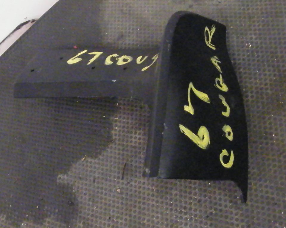 Black car part with yellow writing '67 Cougar R