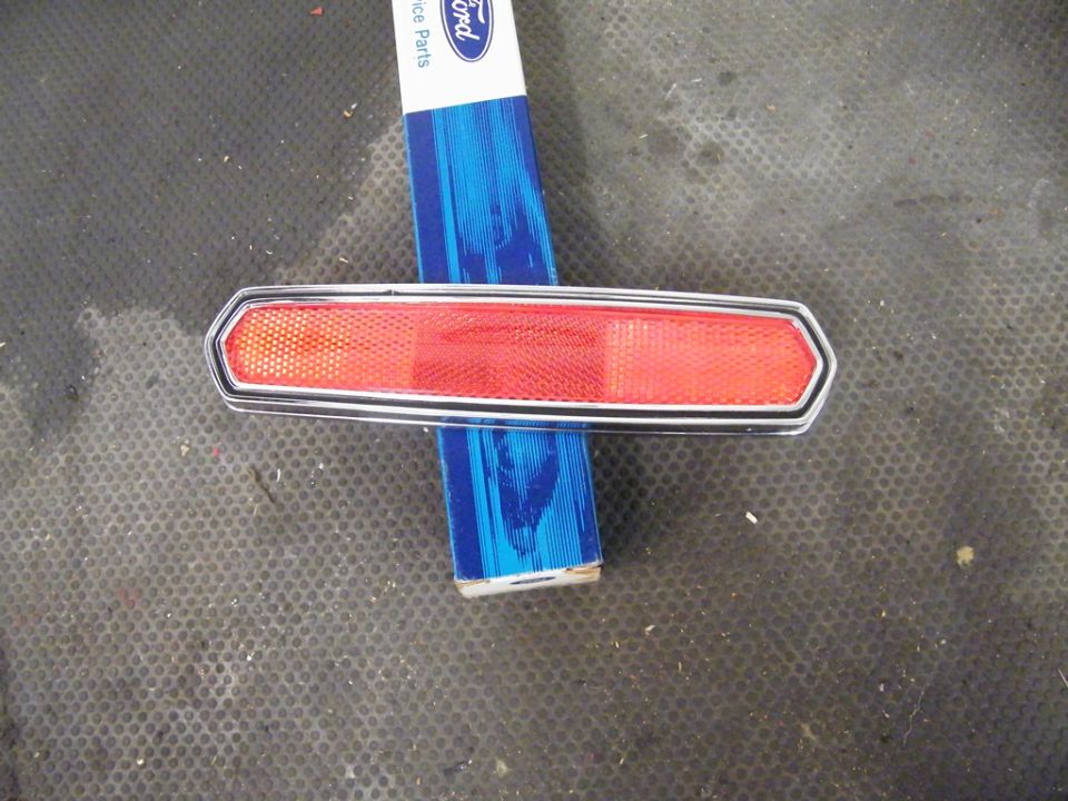 red reflector with chrome trim on blue Ford Service Parts box